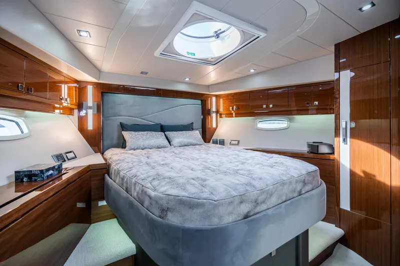  Yacht Photos Pics Luxurious cabin interior of 2026 Neptunus 650F yacht with elegant wood finishes.