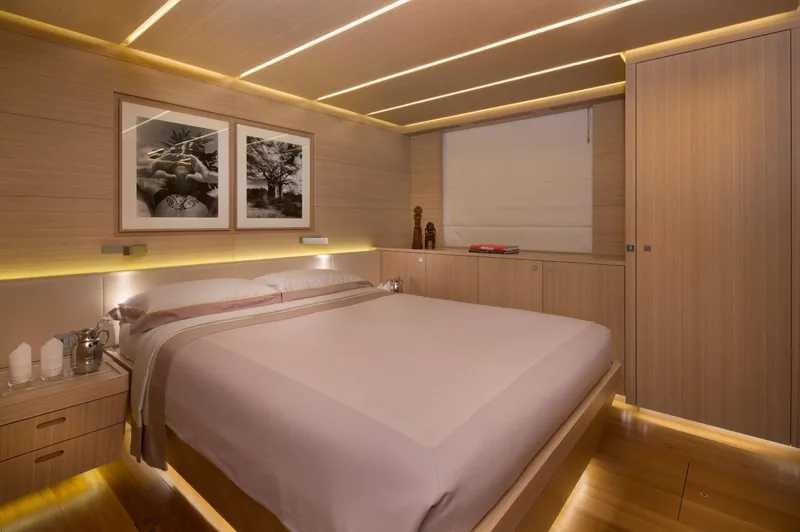Ohana Yacht Photos Pics Luxurious Fitzroy Yachts 49.7m bedroom interior, 2012 model, featuring elegant wood paneling and modern decor.