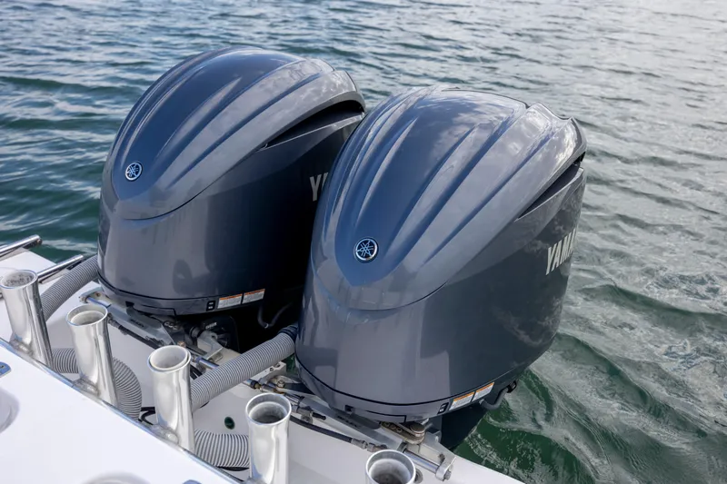  Yacht Photos Pics Twin Yamaha outboard engines on a 2013 Contender 32 Tournament boat in water.