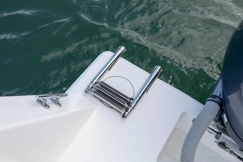  Yacht Photos Pics 2013 Contender 32 Tournament boat with stainless steel ladder and cleat by the water.