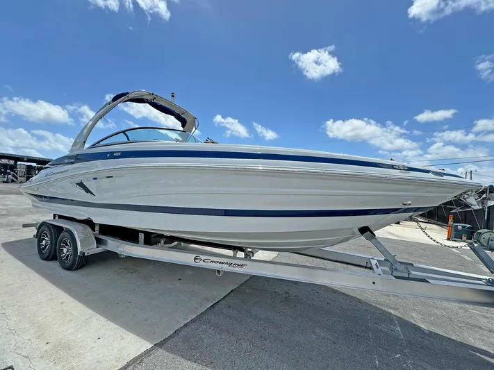  Yacht Photos Pics 2024 Crownline 290 XSS boat on trailer under blue sky.