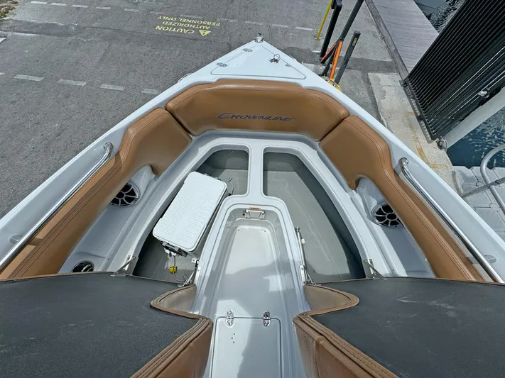  Yacht Photos Pics 2024 Crownline 290 XSS boat interior with tan seating and storage compartments.