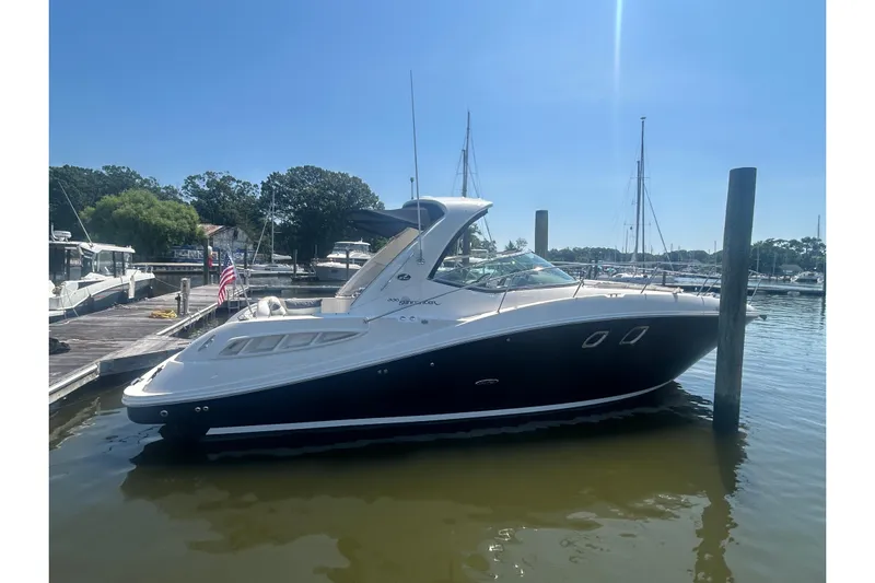  Yacht Photos Pics 2010 Sea Ray Sundancer 330 docked at a marina under clear blue skies.