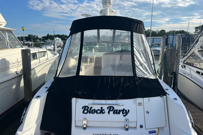  Yacht Photos Pics 2010 Sea Ray Sundancer 330 docked, featuring "Block Party" name, with clear skies above.