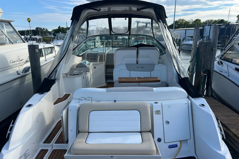  Yacht Photos Pics 2010 Sea Ray Sundancer 330 yacht interior at marina, featuring seating and helm.