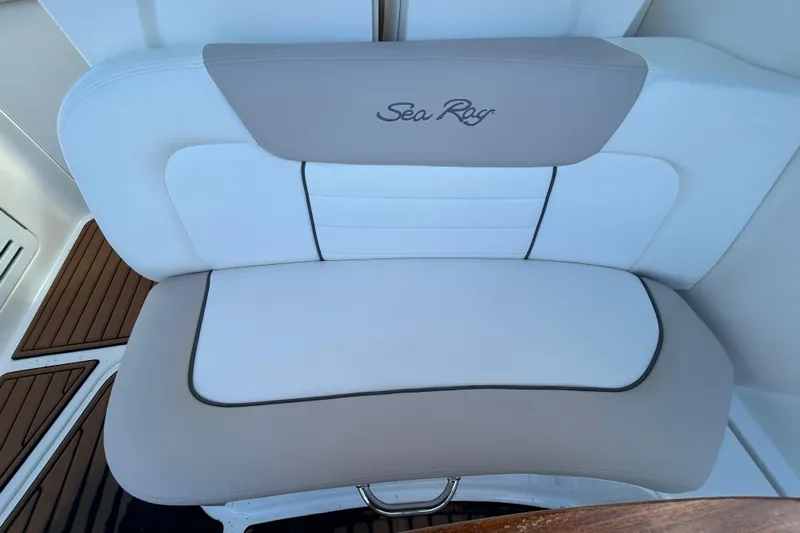  Yacht Photos Pics 2010 Sea Ray Sundancer 330 boat seat with logo, featuring white and beige upholstery.
