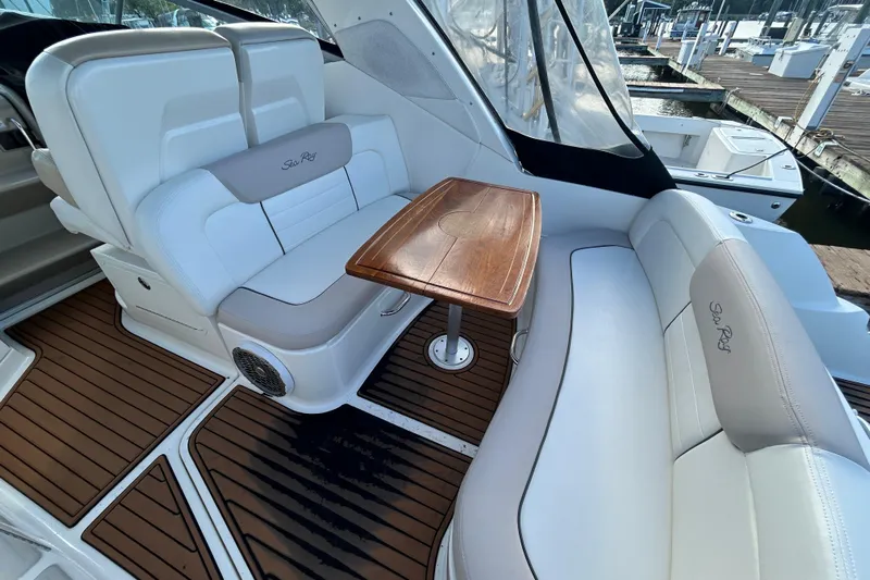  Yacht Photos Pics Luxurious 2010 Sea Ray Sundancer 330 interior with elegant seating and wooden table.