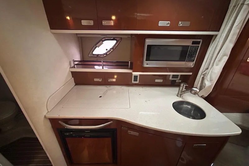  Yacht Photos Pics Compact kitchen area in 2010 Sea Ray Sundancer 330 yacht with sink, microwave, and storage.