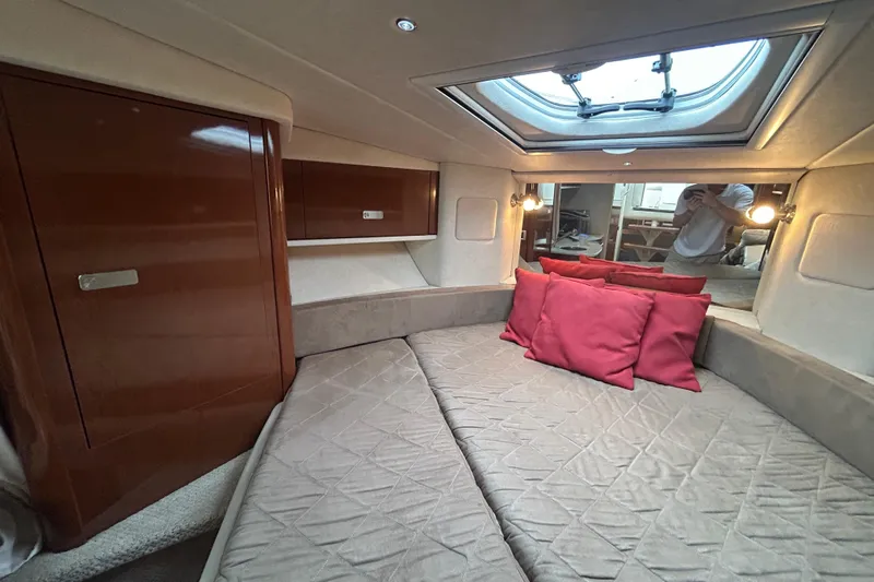  Yacht Photos Pics Luxurious cabin interior of 2010 Sea Ray Sundancer 330 with skylight and red cushions.