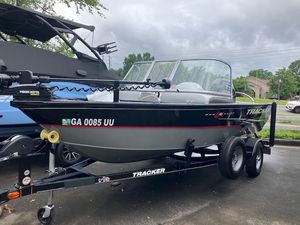 2014 Tracker Pro Guide V-16 WT fishing boat on trailer, parked outdoors.