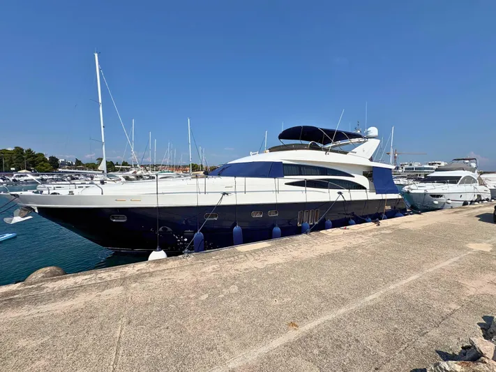  Yacht Photos Pics Luxury Princess 21M yacht from 2007 docked at a marina under clear blue skies.