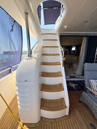  Yacht Photos Pics Staircase on 2007 Princess 21M yacht, leading to upper deck with elegant interior view.