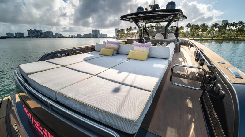 Love$ick Yacht Photos Pics 2023 Pardo Yachts P50 luxury yacht with sunbathing deck, docked by palm-lined waterfront.