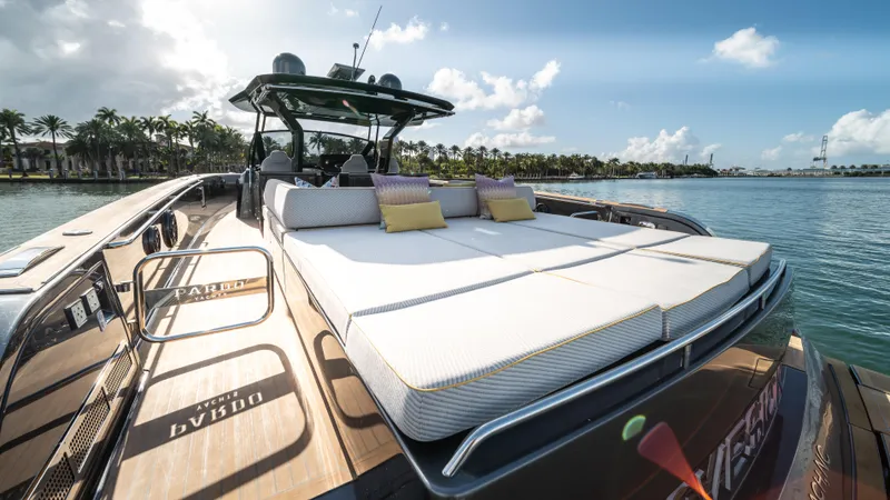 Love$ick Yacht Photos Pics 2023 Pardo Yachts P50 luxury yacht with sunbathing deck, docked by palm trees.