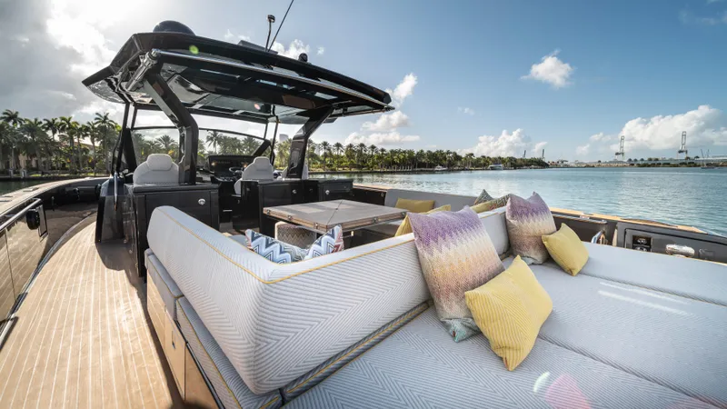Love$ick Yacht Photos Pics Luxurious 2023 Pardo Yachts P50 with elegant deck and plush seating, cruising on serene waters.