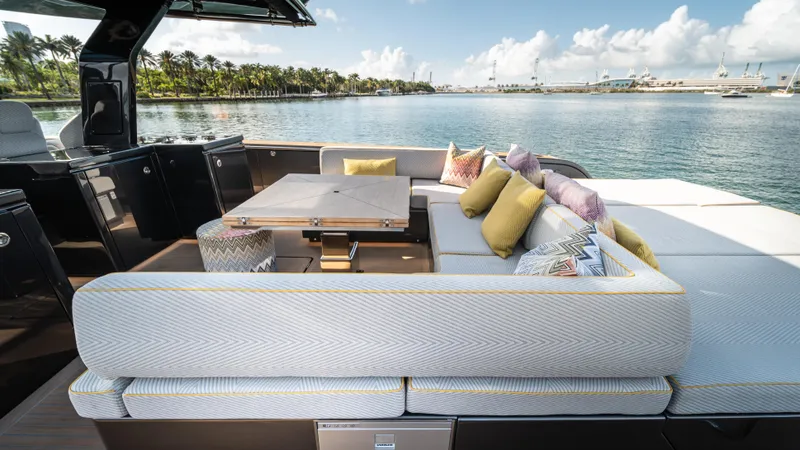 Love$ick Yacht Photos Pics Luxurious 2023 Pardo Yachts P50 with elegant outdoor seating and scenic waterfront view.