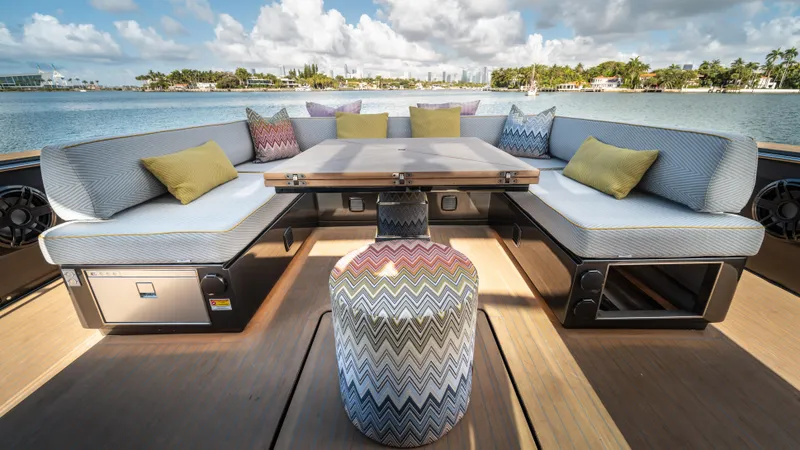 Love$ick Yacht Photos Pics Luxurious 2023 Pardo Yachts P50 deck with elegant seating and scenic waterfront view.