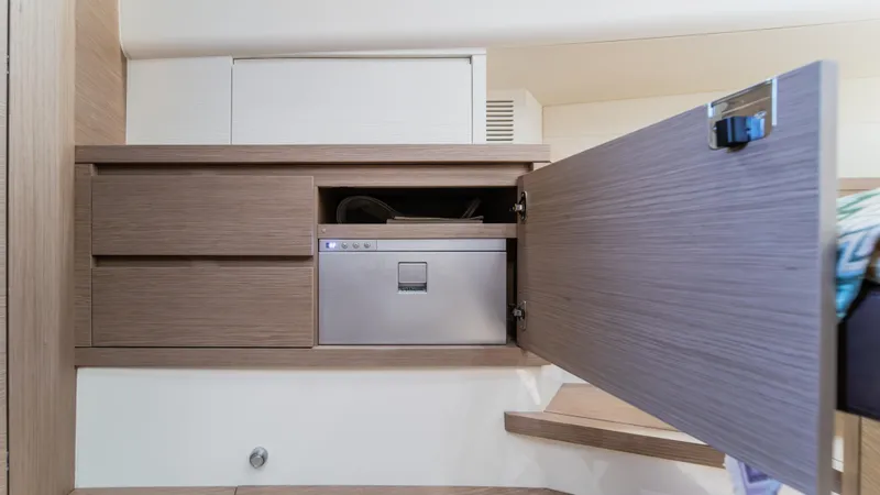 Love$ick Yacht Photos Pics 2023 Pardo Yachts P50 interior with open wooden cabinet and built-in appliance.