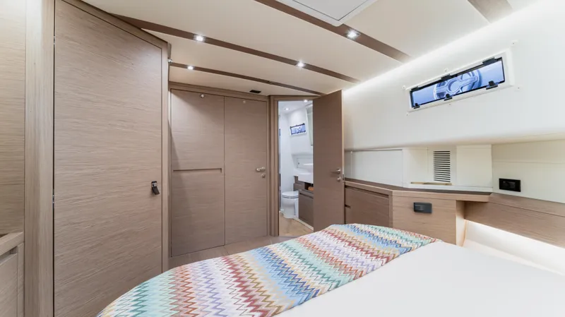 Love$ick Yacht Photos Pics Luxurious cabin interior of 2023 Pardo Yachts P50 with modern design and cozy bedding.