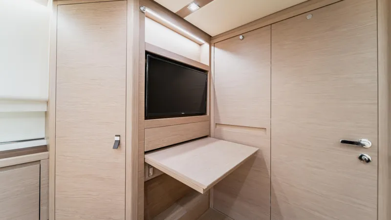 Love$ick Yacht Photos Pics 2023 Pardo Yachts P50 interior with foldable table and built-in TV.