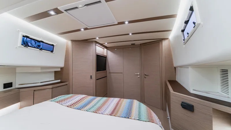 Love$ick Yacht Photos Pics Luxurious interior of 2023 Pardo Yachts P50, featuring modern design and cozy bedroom.
