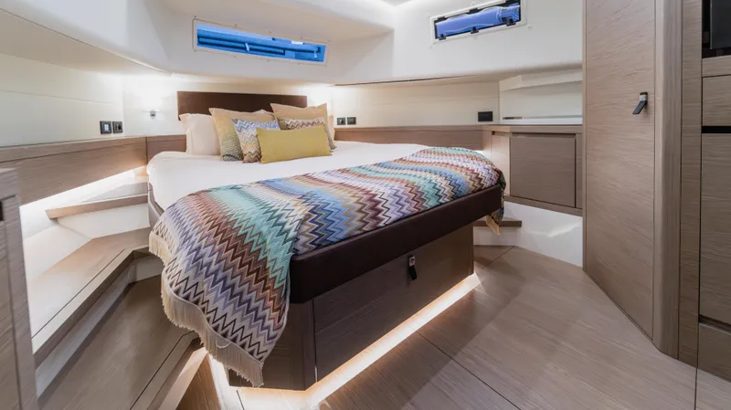 Love$ick Yacht Photos Pics Luxurious cabin interior of 2023 Pardo Yachts P50 with modern design and cozy bedding.