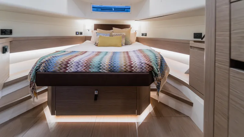 Love$ick Yacht Photos Pics Luxurious cabin interior of 2023 Pardo Yachts P50 with stylish bedding and ambient lighting.
