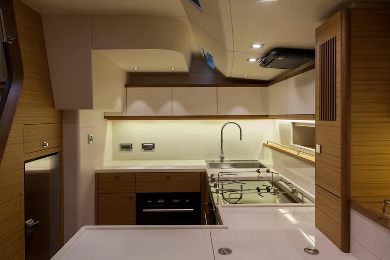  Yacht Photos Pics Luxurious kitchen interior of 2017 Mazarin 72 Cruiser/Racer yacht with modern appliances and sleek design.