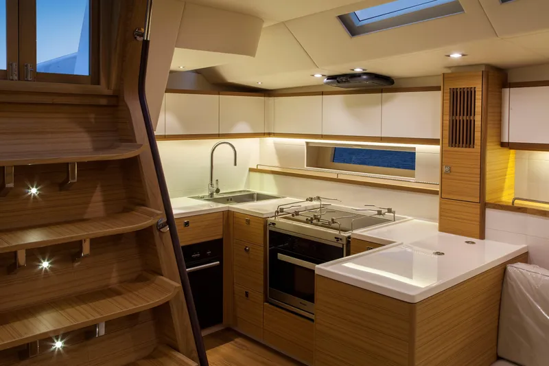  Yacht Photos Pics Luxurious kitchen interior of 2017 Mazarin 72 Cruiser/Racer yacht with modern wood finish.