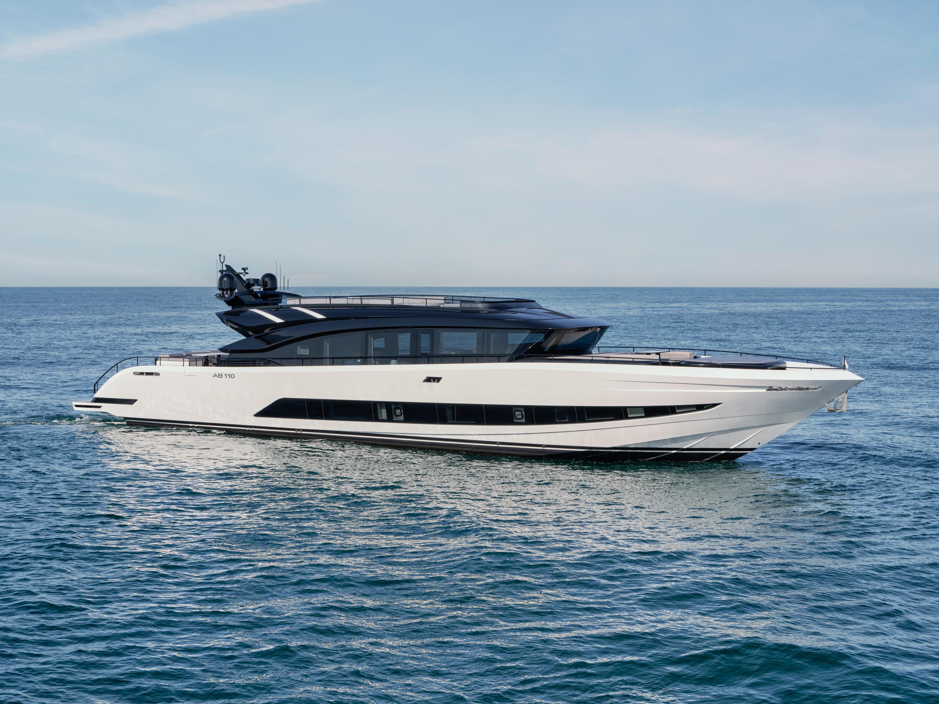Luxury yacht AB 110, 2025 model, cruising on open sea under clear skies.