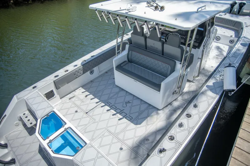  Yacht Photos Pics 2025 Sedna 37 Open boat with spacious deck and seating, docked by the water.