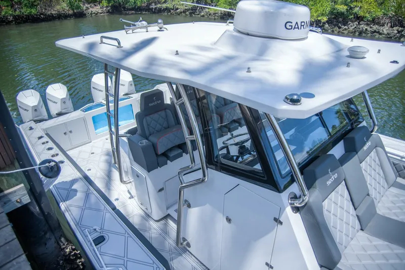  Yacht Photos Pics 2025 Sedna 37 Open boat with sleek design and modern features docked by a river.