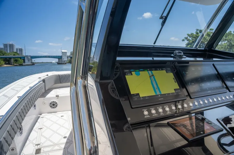  Yacht Photos Pics 2025 Sedna 37 Open boat cockpit with navigation system, cruising on a river.