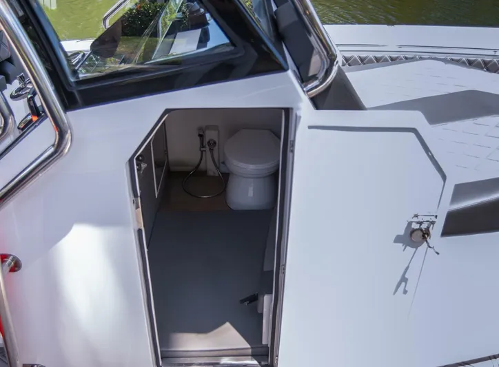  Yacht Photos Pics Sedna 37 Open 2025 boat with open cabin door revealing interior toilet.