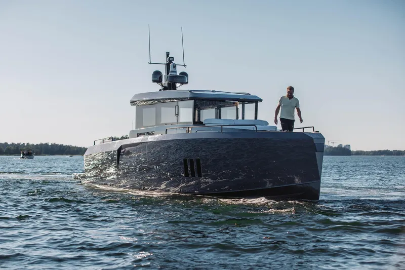  Yacht Photos Pics 2026 XO Boats EXPLR 44 cruising on open water with a person on deck.