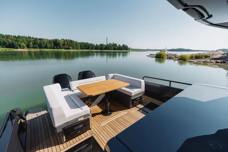  Yacht Photos Pics 2026 XO Boats EXPLR 44 deck with seating, table, and scenic water view.