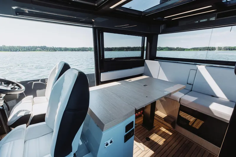  Yacht Photos Pics Interior of 2026 XO Boats EXPLR 44, featuring modern seating and panoramic windows.