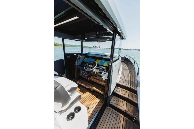  Yacht Photos Pics 2026 XO Boats EXPLR 44 helm with modern navigation system and sleek wooden deck.