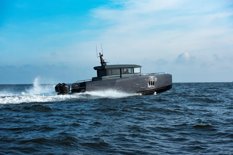  Yacht Photos Pics 2026 XO Boats EXPLR 44 cruising on open water under a clear blue sky.