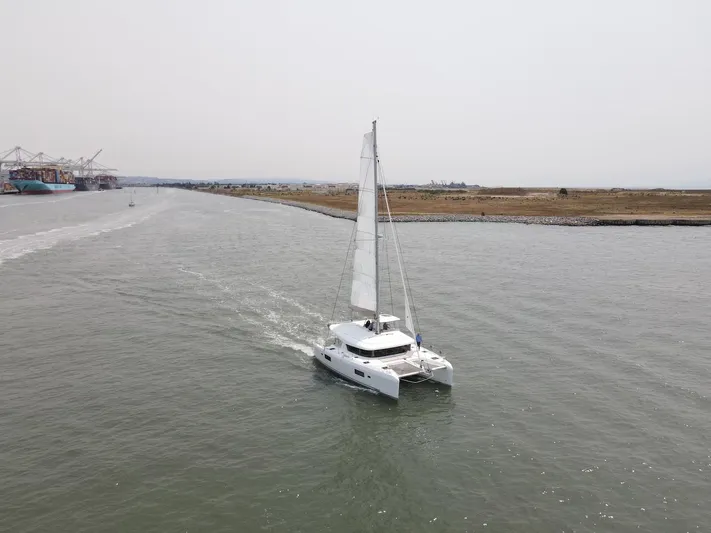 Hullchal Yacht Photos Pics 2021 Lagoon 42 catamaran sailing in a calm waterway.