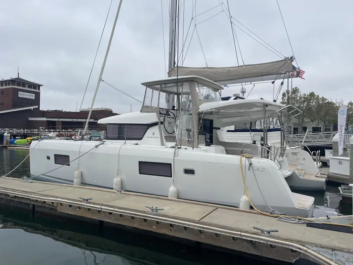 Hullchal Yacht Photos Pics 2021 Lagoon 42 catamaran docked at a marina, featuring sleek design and modern amenities.