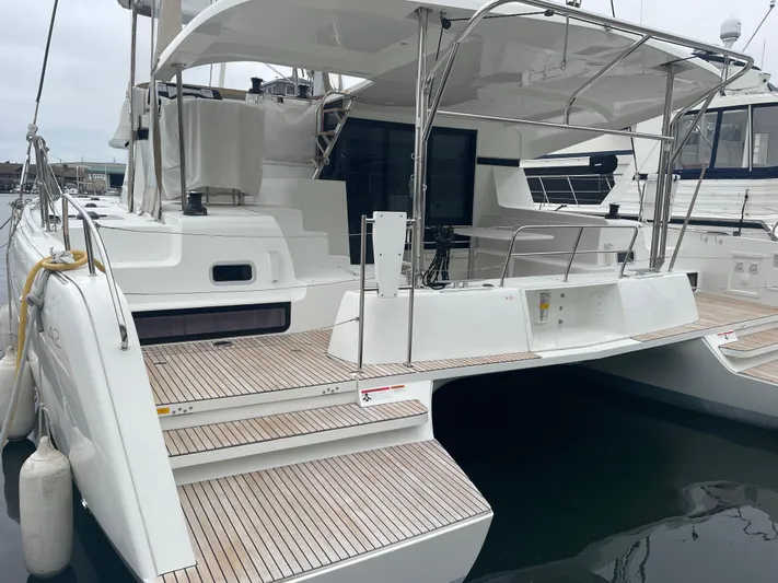 Hullchal Yacht Photos Pics 2021 Lagoon 42 catamaran with spacious deck and modern design, docked at marina.