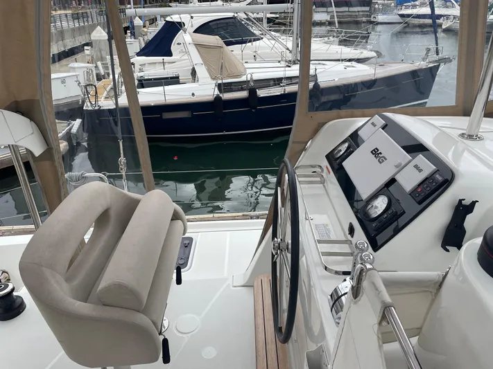Hullchal Yacht Photos Pics Helm of 2021 Lagoon 42 catamaran in marina, featuring modern navigation equipment.