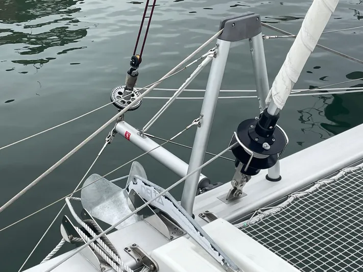 Hullchal Yacht Photos Pics Close-up of 2021 Lagoon 42 sailboat rigging and anchor system on calm water.
