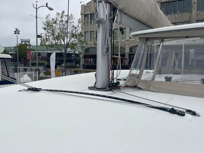 Hullchal Yacht Photos Pics 2021 Lagoon 42 catamaran deck with mast and rigging in marina setting.