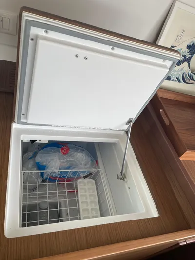Hullchal Yacht Photos Pics Open freezer compartment on Lagoon 42 yacht, 2021 model, with ice packs and tray inside.