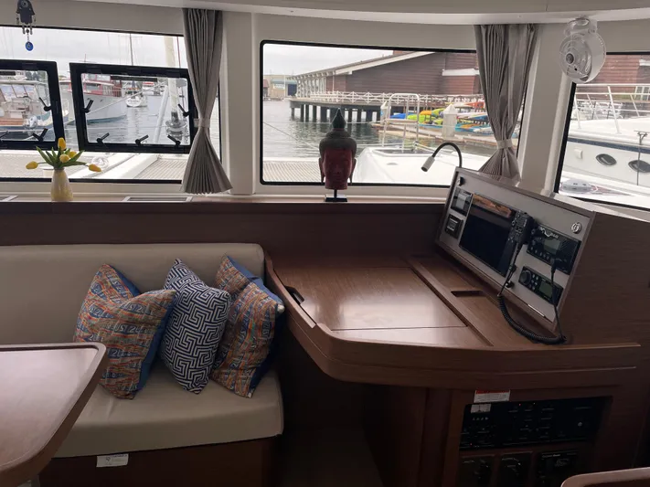 Hullchal Yacht Photos Pics Interior of 2021 Lagoon 42 yacht with seating, cushions, and navigation station.