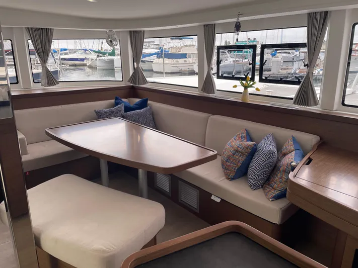 Hullchal Yacht Photos Pics Interior of 2021 Lagoon 42 catamaran with elegant seating and marina view.