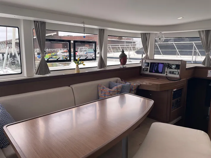 Hullchal Yacht Photos Pics Interior of 2021 Lagoon 42 catamaran with dining area and navigation station.