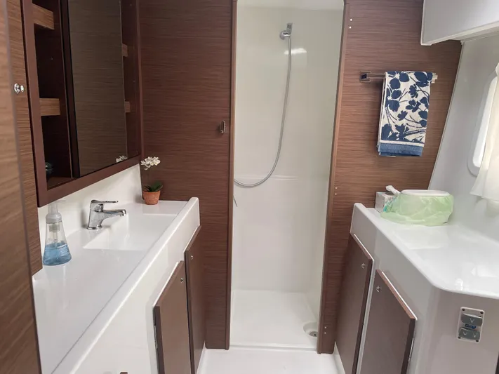 Hullchal Yacht Photos Pics Modern bathroom in 2021 Lagoon 42 yacht with shower, sink, and wooden accents.